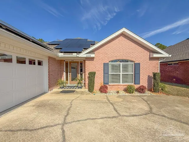 a front view of a house with basket ball court and a garage