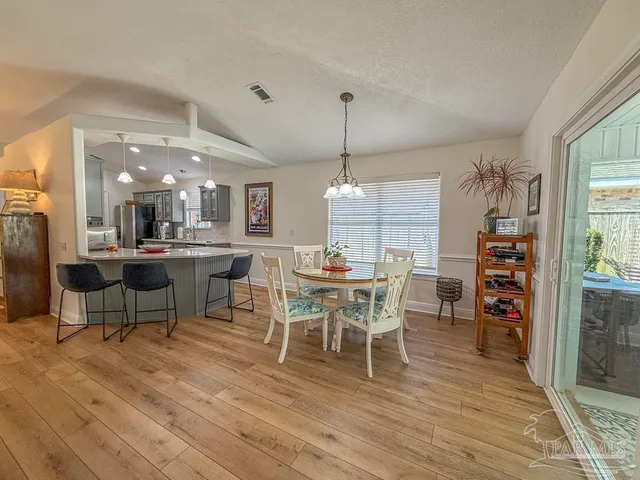 a view of a dining room with furniture and wooden floor
