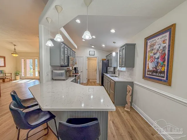 a view of kitchen with cabinets and wooden floor
