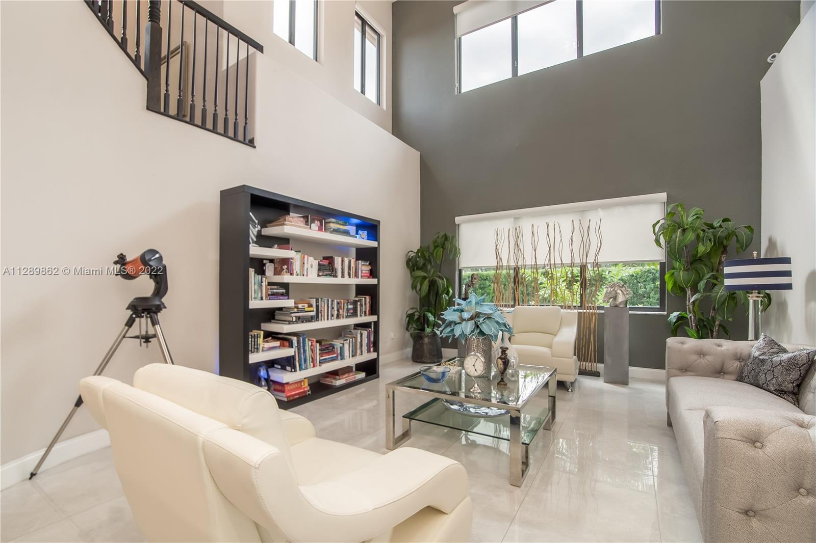 7783 Southwest 188th Street Cutler Bay, FL 33157 - Photo 14 of 70 a living room with furniture and a book shelf