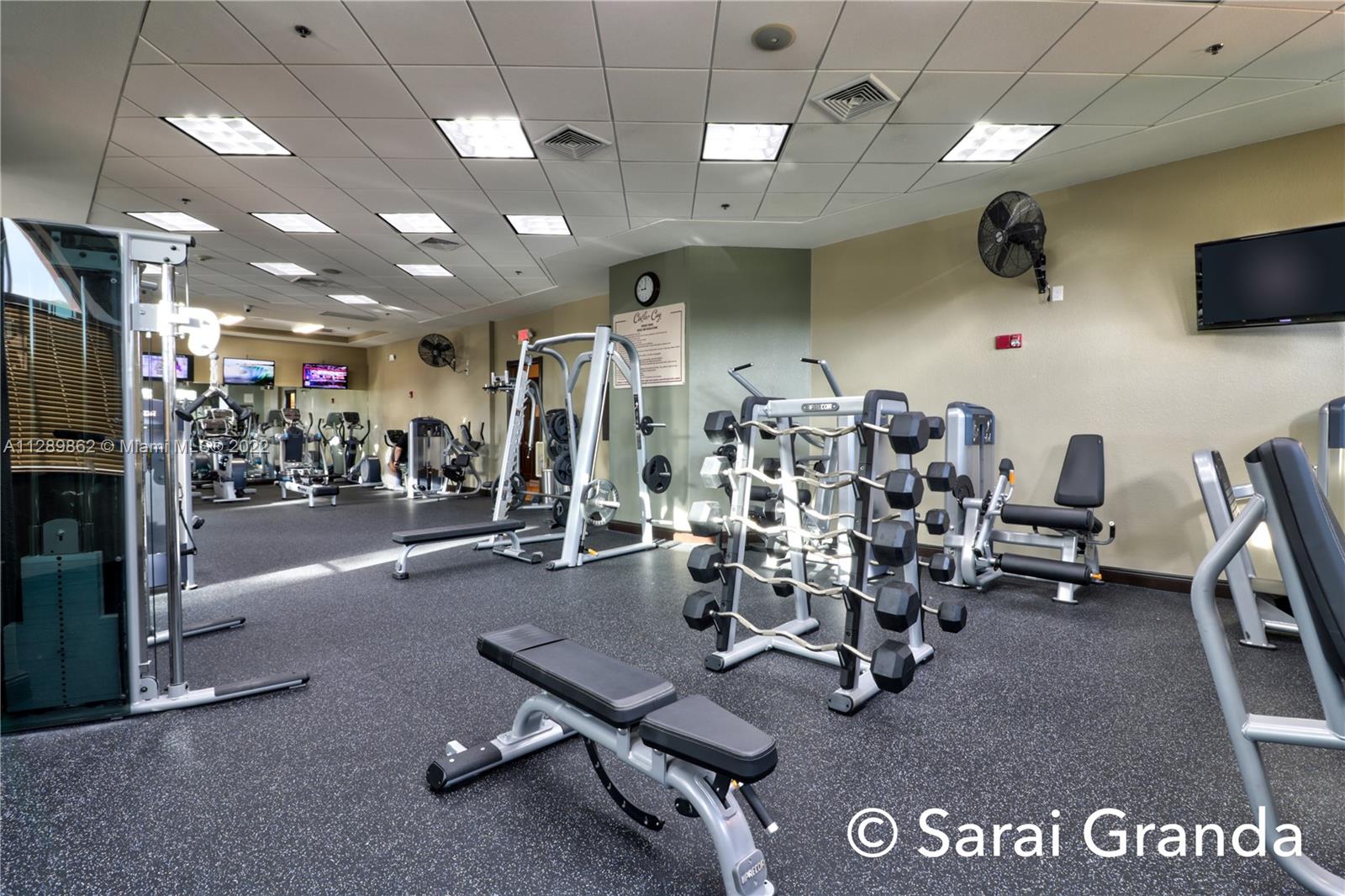7783 Southwest 188th Street Cutler Bay, FL 33157 - Photo 18 of 70 a room with gym equipment and a large window