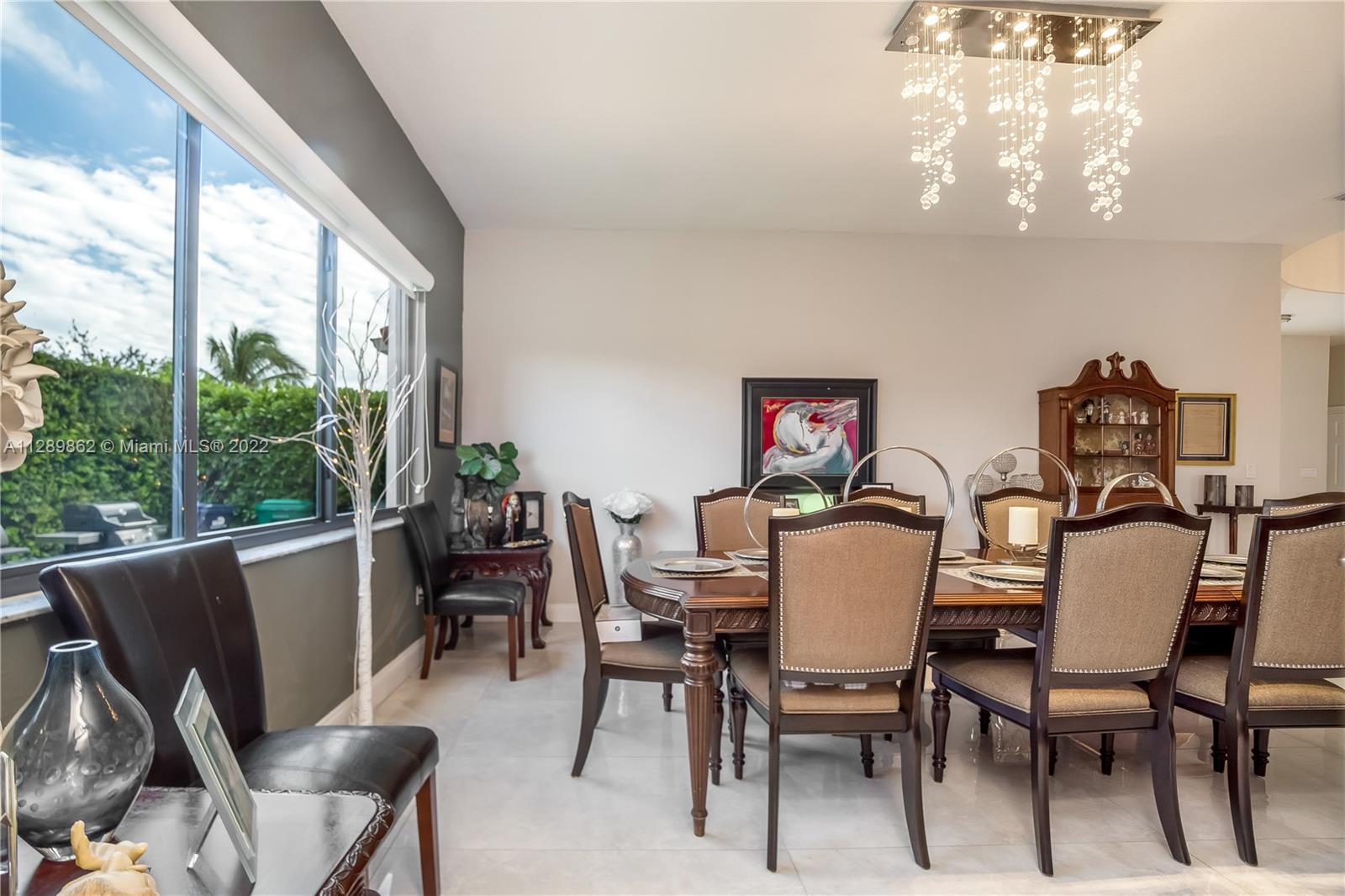 7783 Southwest 188th Street Cutler Bay, FL 33157 - Photo 19 of 70 a view of a dining room with furniture window and outside view
