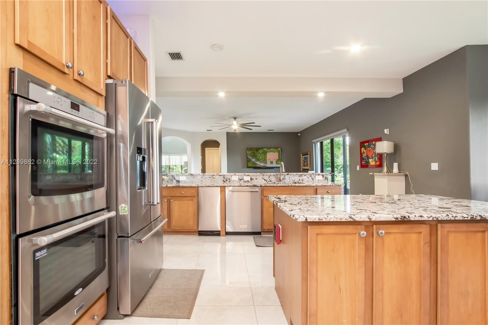 7783 Southwest 188th Street Cutler Bay, FL 33157 - Photo 28 of 70 a kitchen with granite countertop a sink stainless steel appliances and counter space