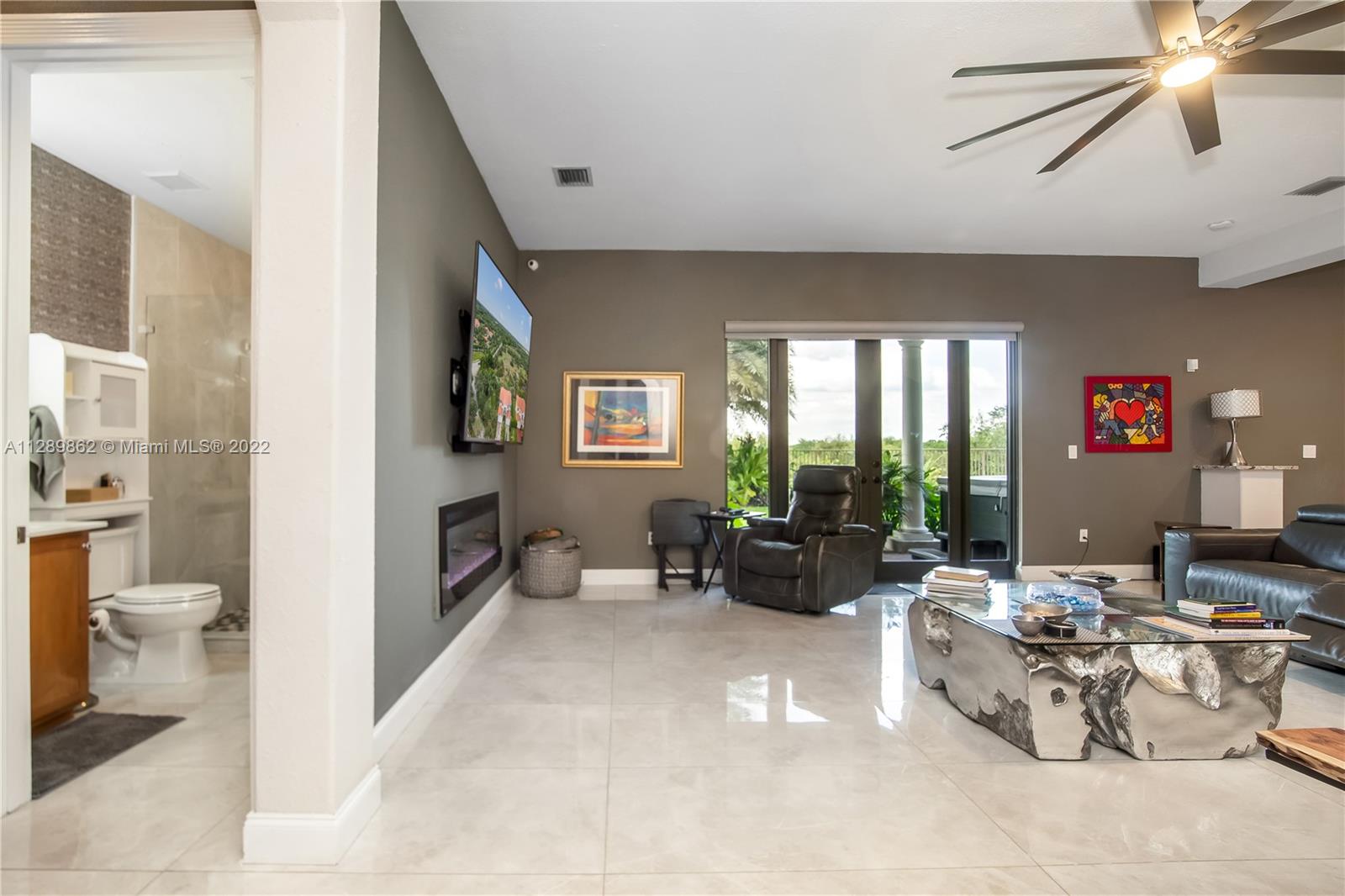 7783 Southwest 188th Street Cutler Bay, FL 33157 - Photo 31 of 70 a living room with furniture and a large window
