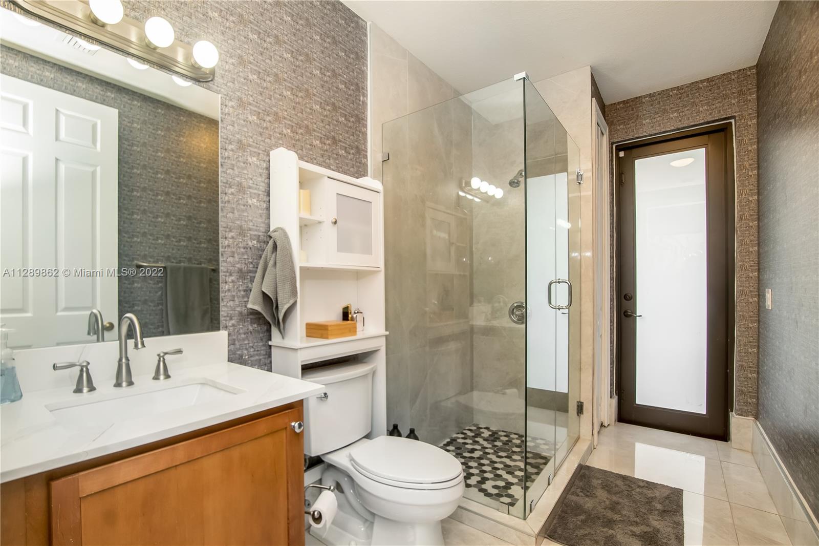 7783 Southwest 188th Street Cutler Bay, FL 33157 - Photo 32 of 70 a bathroom with a sink toilet vanity and shower