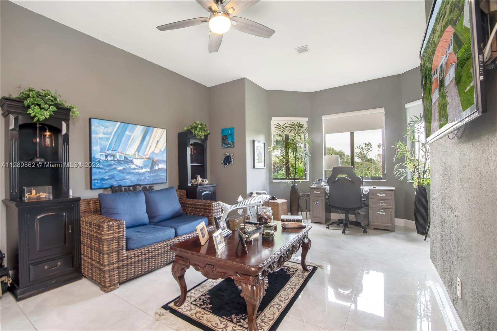 7783 Southwest 188th Street Cutler Bay, FL 33157 - Photo 33 of 70 a living room with furniture and a large window
