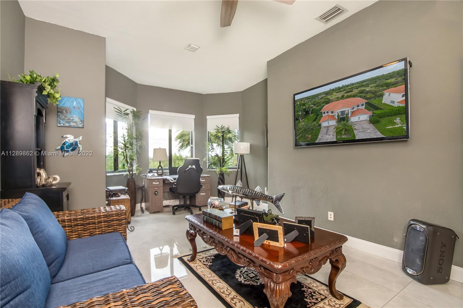 7783 Southwest 188th Street Cutler Bay, FL 33157 - Photo 34 of 70 a living room with furniture and a flat screen tv