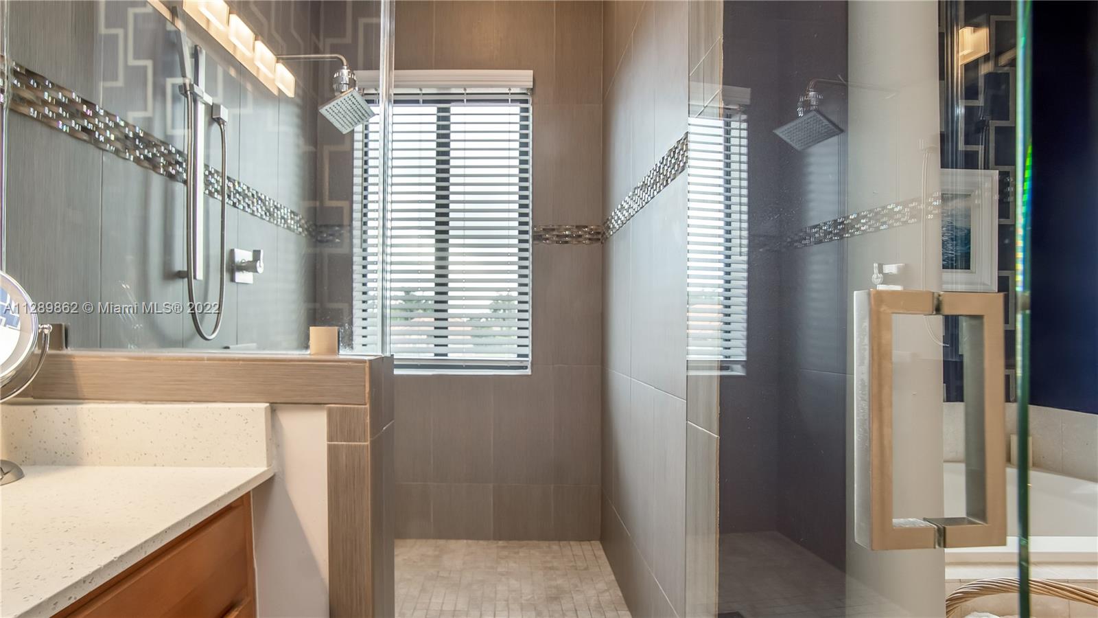 7783 Southwest 188th Street Cutler Bay, FL 33157 - Photo 44 of 70 a bathroom with a tub sink and a mirror