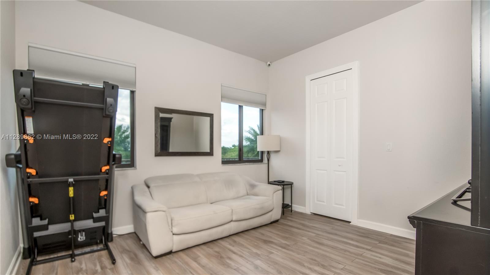7783 Southwest 188th Street Cutler Bay, FL 33157 - Photo 54 of 70 a living room with furniture and a flat screen tv