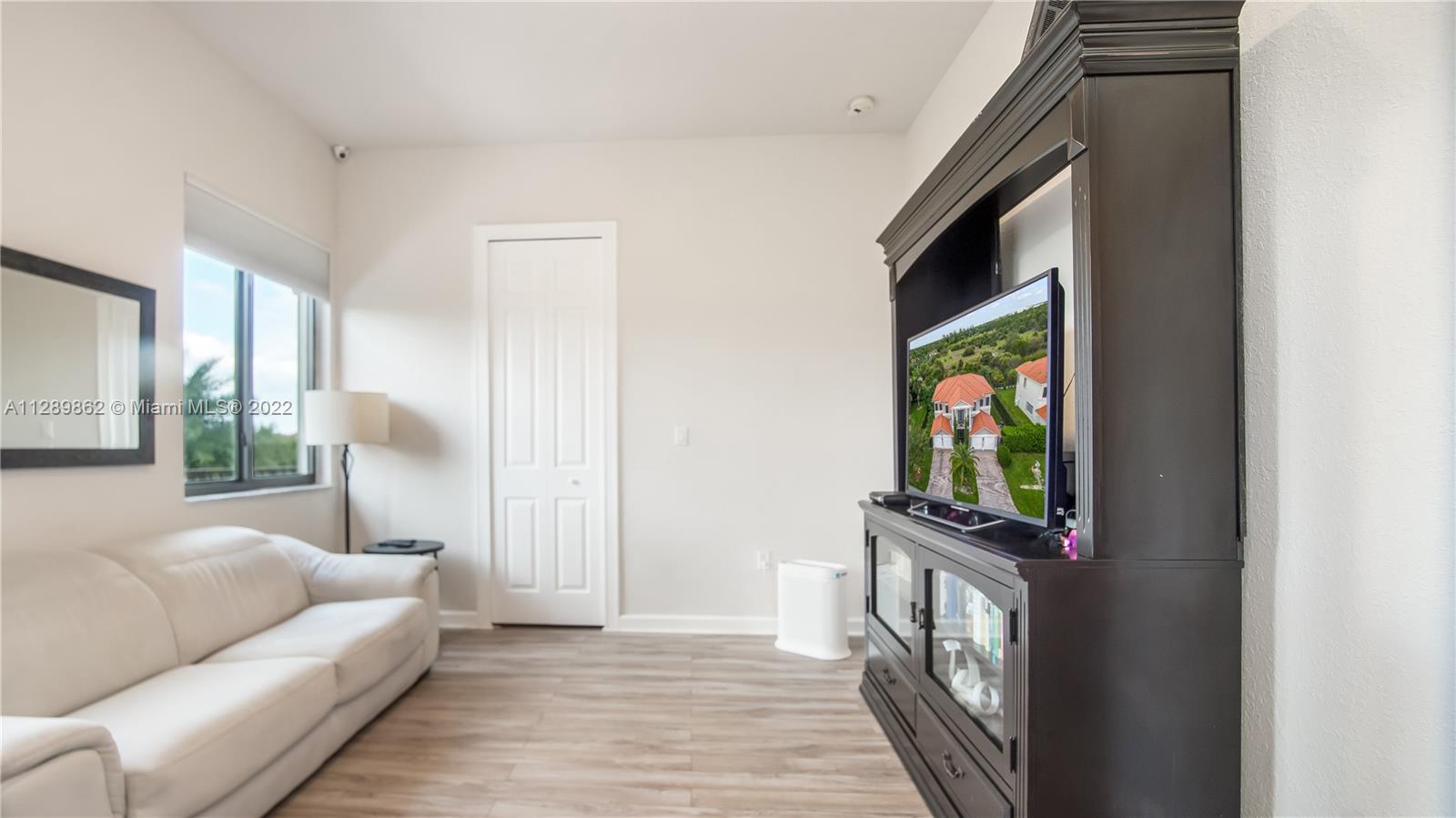 7783 Southwest 188th Street Cutler Bay, FL 33157 - Photo 55 of 70 a living room with furniture and a flat screen tv