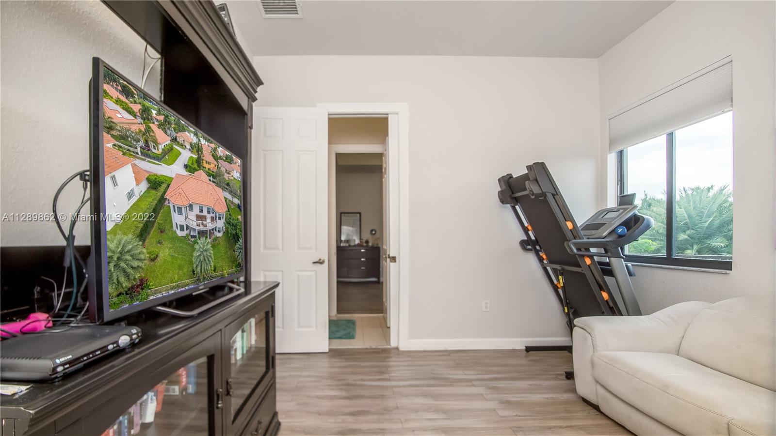 7783 Southwest 188th Street Cutler Bay, FL 33157 - Photo 56 of 70 a living room with furniture and a flat screen tv