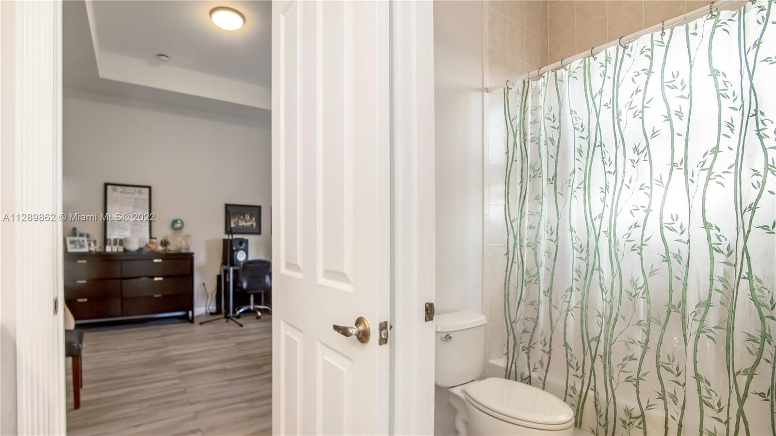 7783 Southwest 188th Street Cutler Bay, FL 33157 - Photo 58 of 70 a bathroom with a granite countertop sink toilet and shower