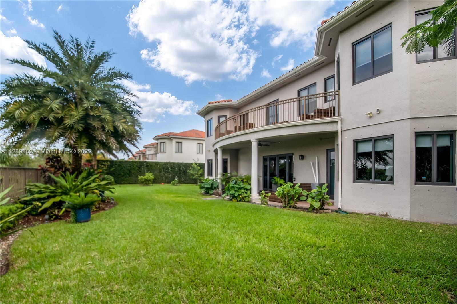 7783 Southwest 188th Street Cutler Bay, FL 33157 - Photo 61 of 70 a view of a house with brick walls and a yard with plants
