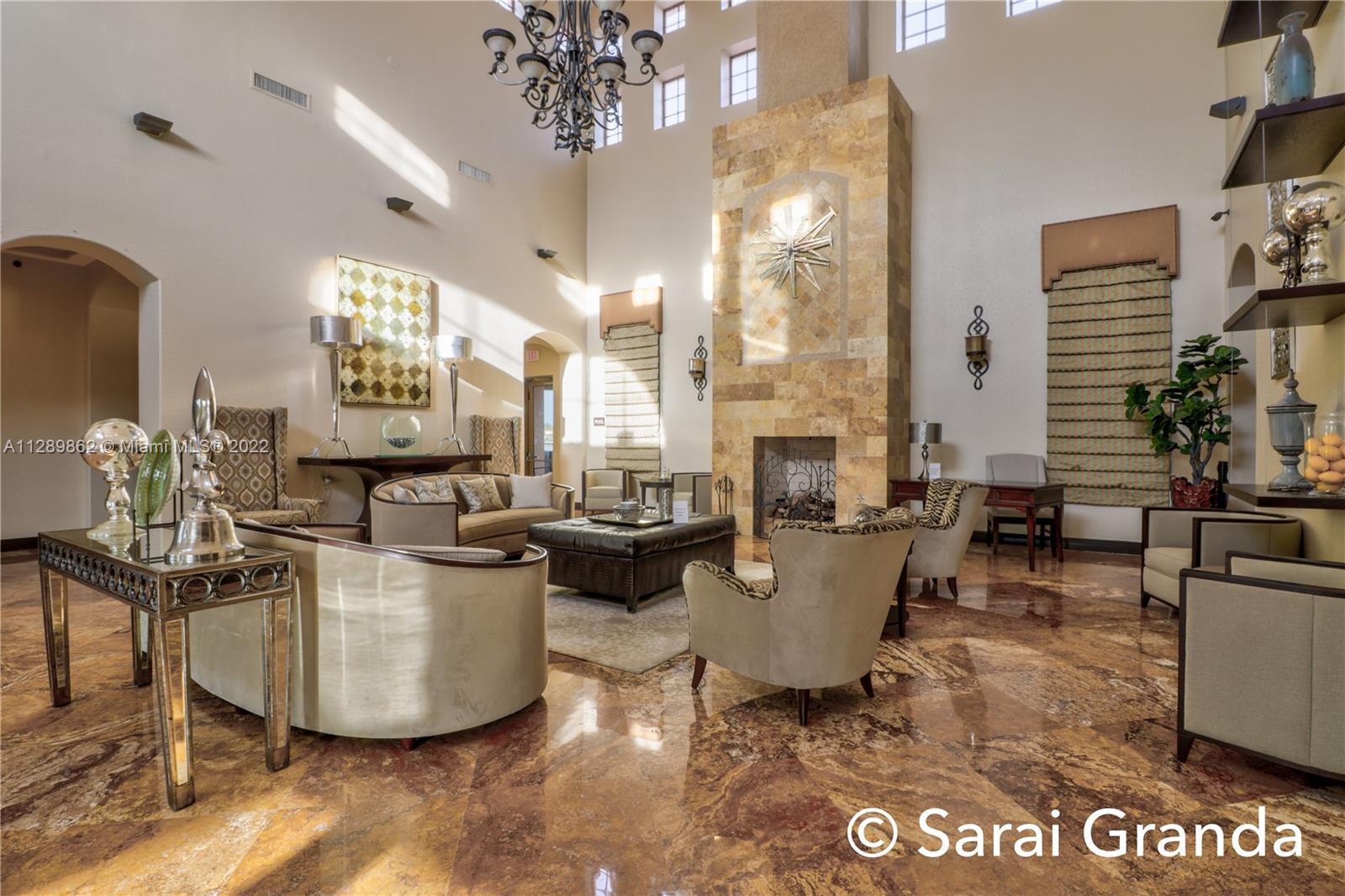 7783 Southwest 188th Street Cutler Bay, FL 33157 - Photo 64 of 70 a living room with fireplace furniture and a chandelier