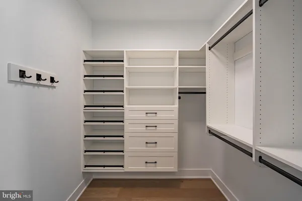 a view of walk in closet with empty racks