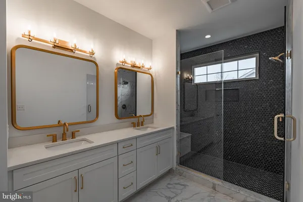a bathroom with a double vanity sink and mirror