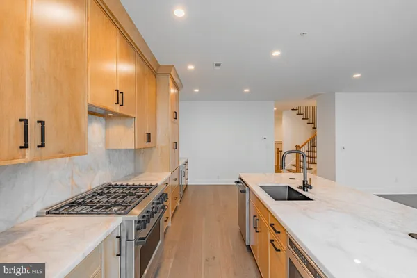 a kitchen with a sink a stove and a refrigerator