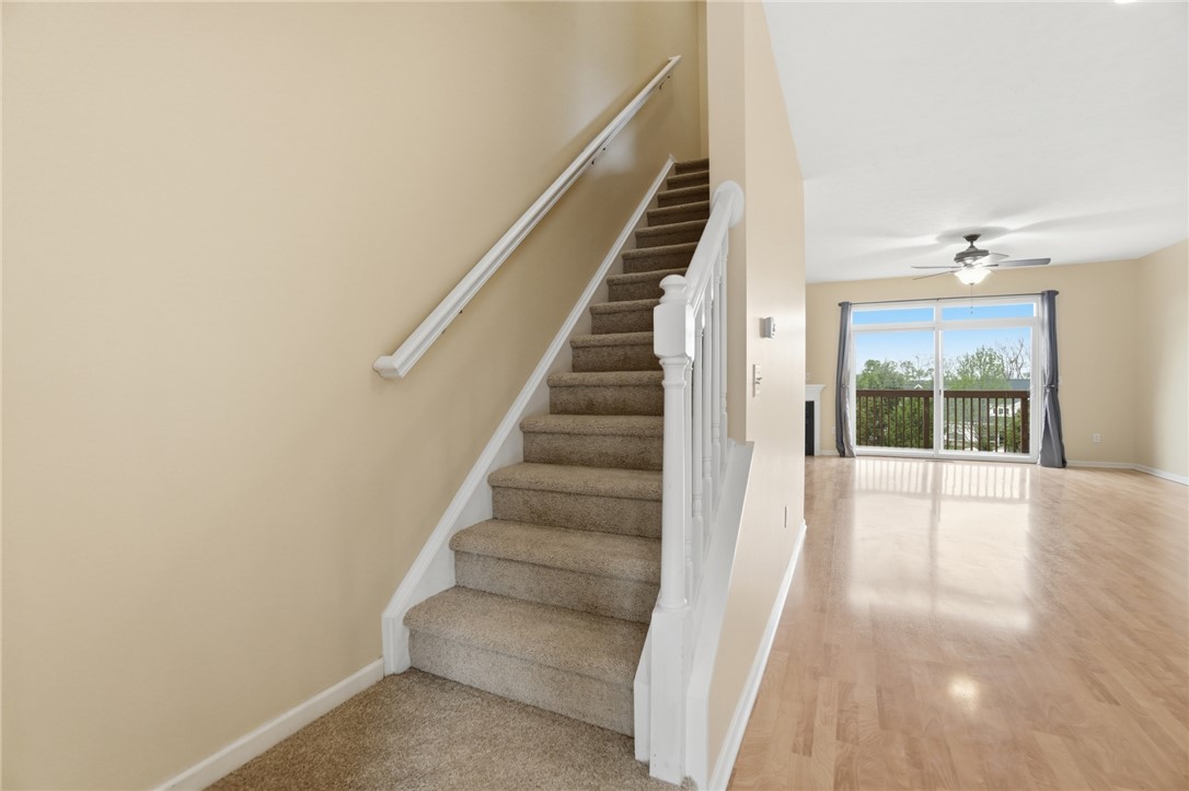 4324 Straight Arrow Road Dayton, OH 45430 - Photo 6 of 40 This bright space features a carpeted staircase, hardwood flooring, and a sliding glass door leading to an outdoor deck.