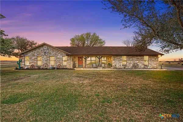 a front view of a house with a big yard