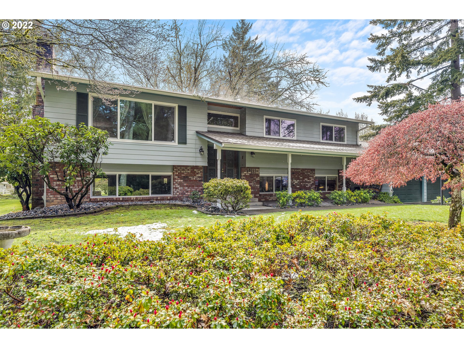 30026 Southeast Chase Road Gresham, OR 97080 - Photo 1 of 32 a front view of house with yard and trees in the background