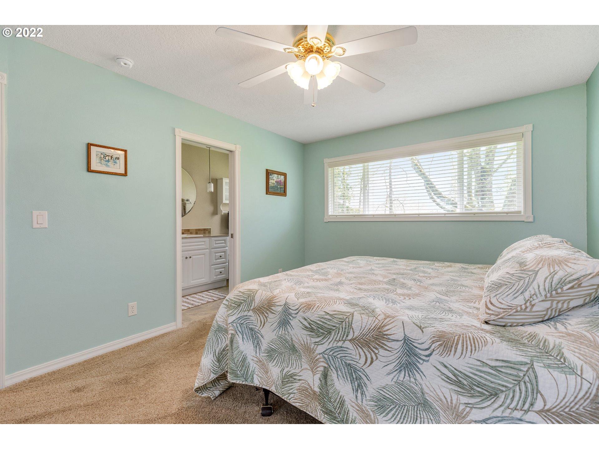 30026 Southeast Chase Road Gresham, OR 97080 - Photo 11 of 32 a bedroom with a bed and a chandelier
