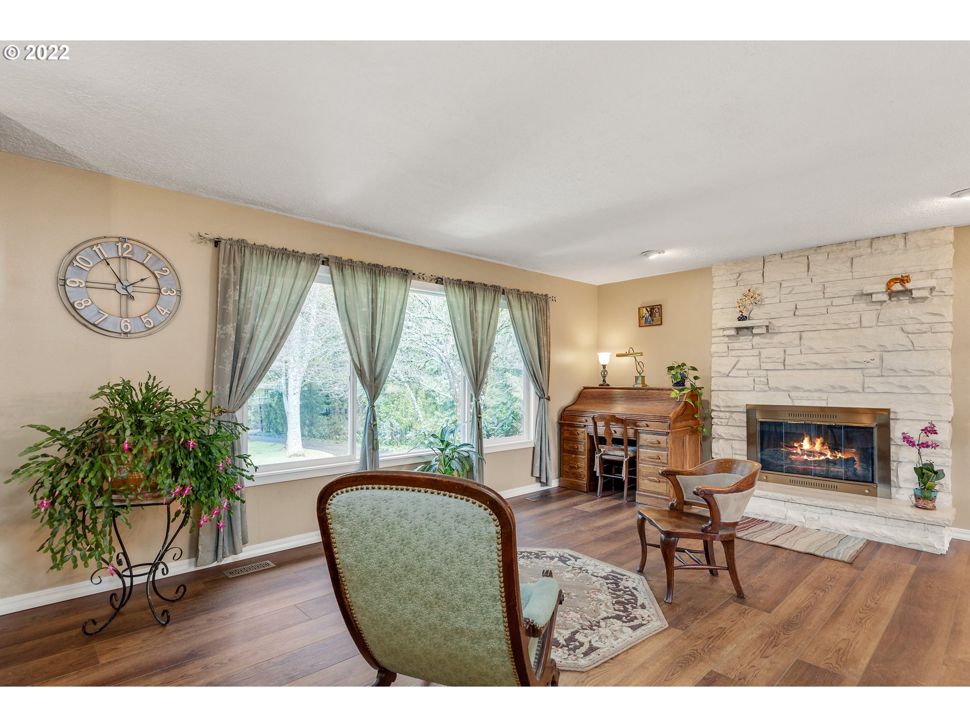 30026 Southeast Chase Road Gresham, OR 97080 - Photo 5 of 32 a living room with furniture a fireplace and a large window