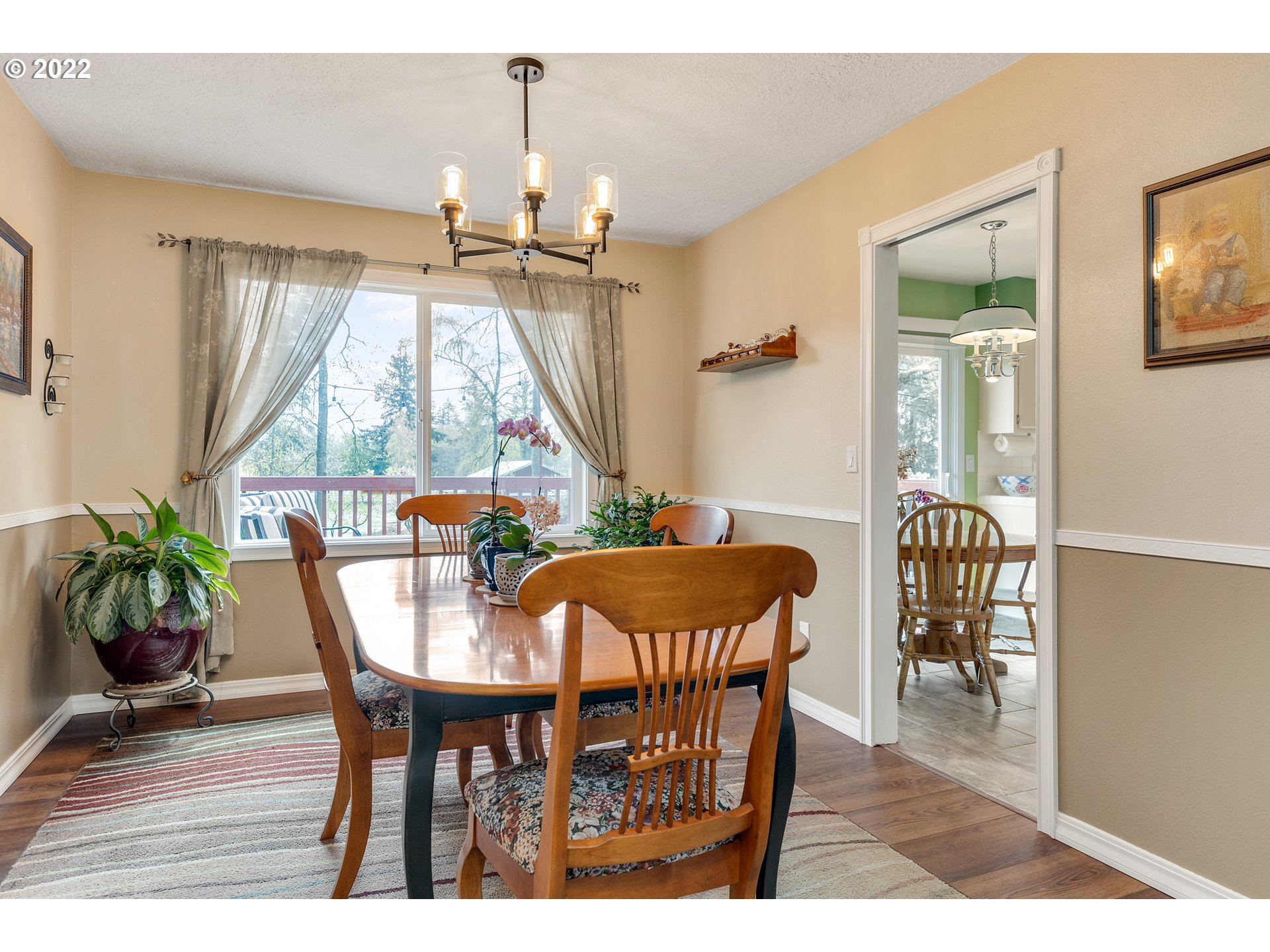 30026 Southeast Chase Road Gresham, OR 97080 - Photo 6 of 32 a dining room with furniture potted plants and wooden floor