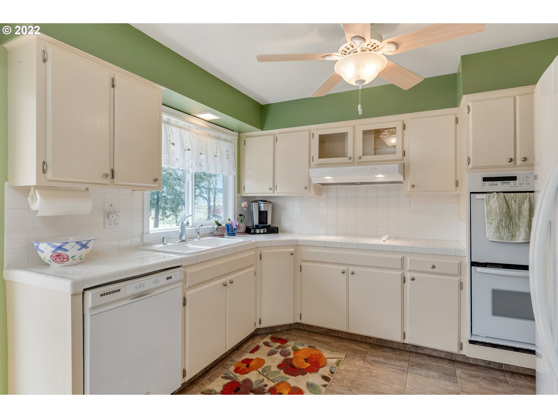 30026 Southeast Chase Road Gresham, OR 97080 - Photo 8 of 32 a kitchen with stainless steel appliances granite countertop a sink window and cabinets