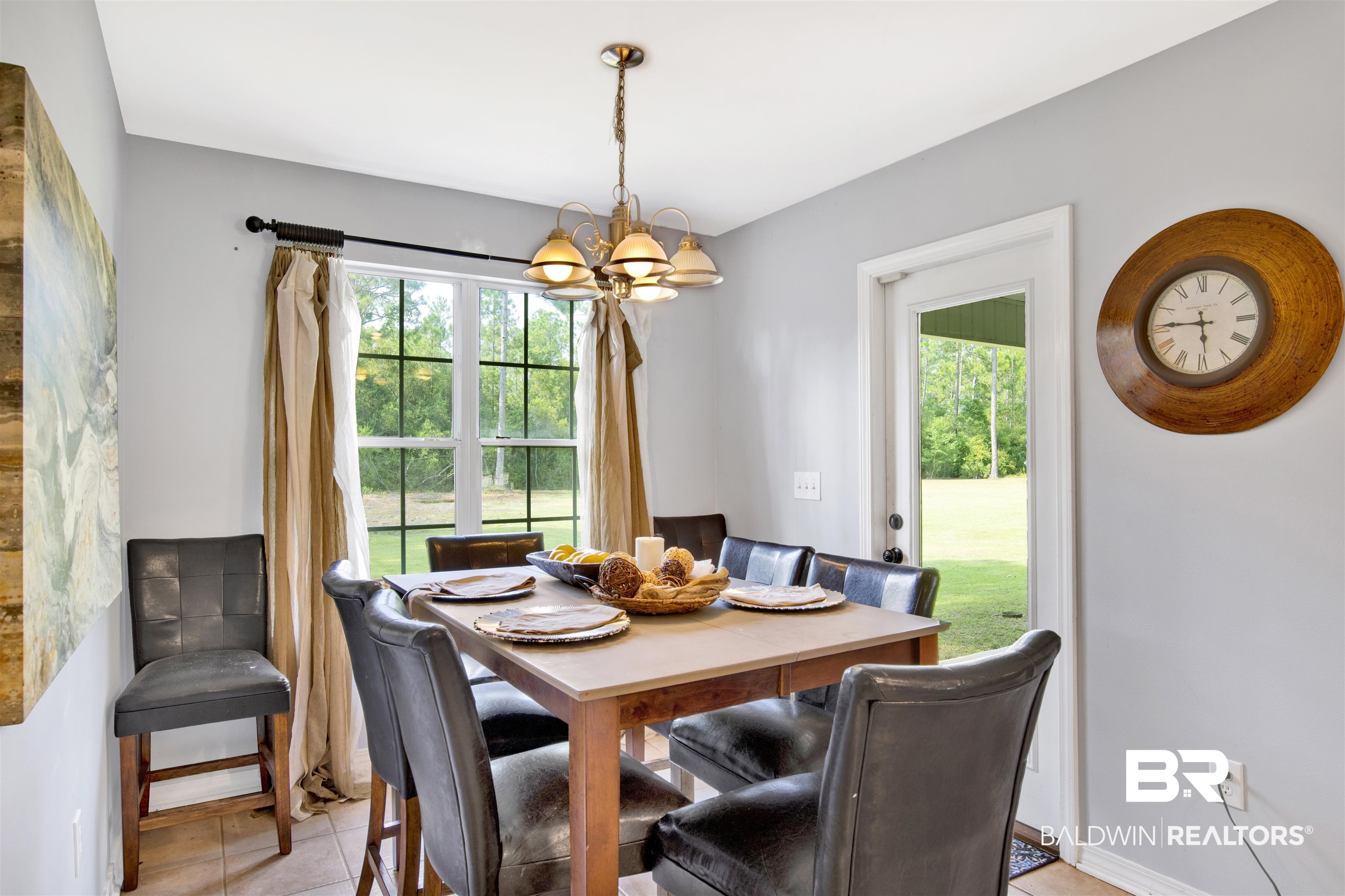 24384 Sailfish Lane Orange Beach, AL 36561 - Photo 10 of 23 Dining area featuring light tile patterned flooring and a notable chandelier