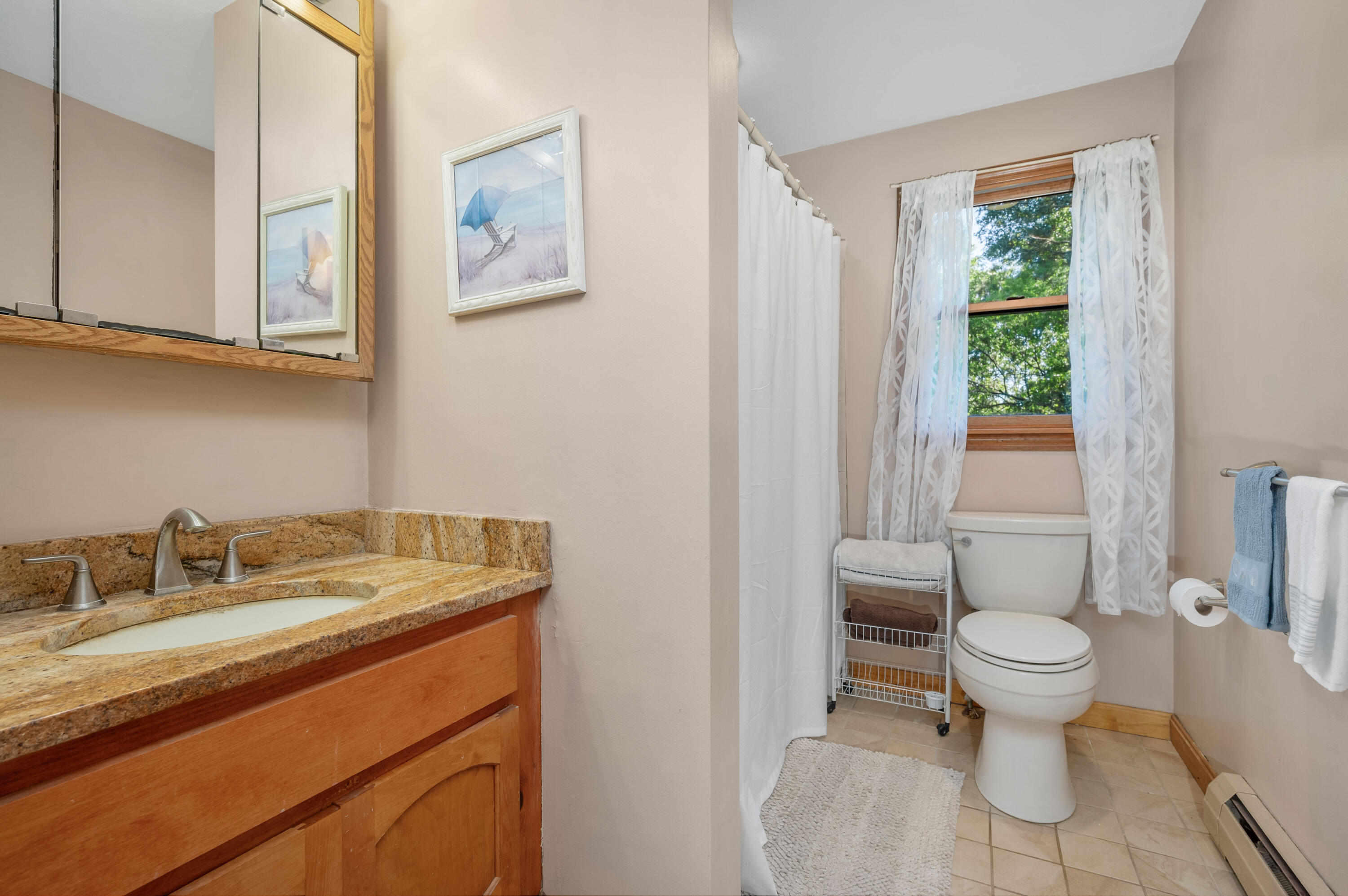 364 Jones Road Marstons Mills, MA 02648 - Photo 14 of 24 a bathroom with a granite countertop sink a toilet and a window