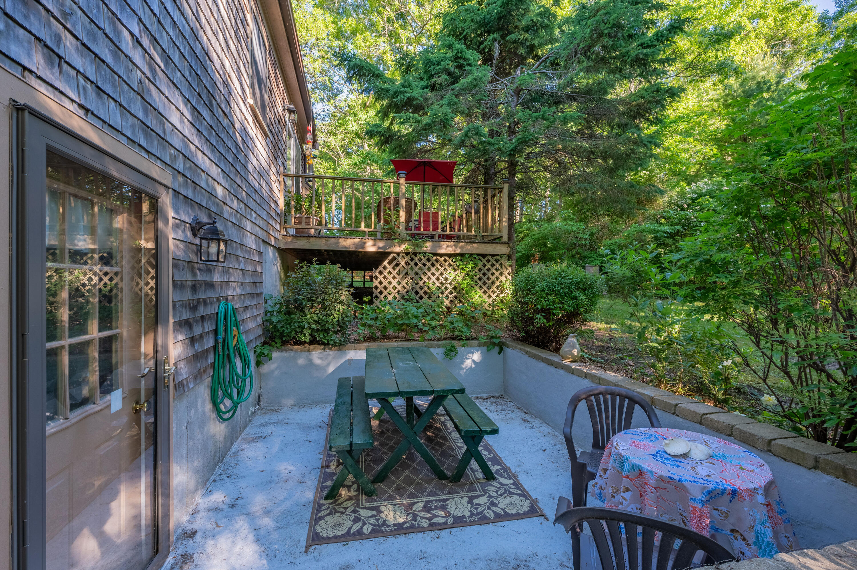 364 Jones Road Marstons Mills, MA 02648 - Photo 22 of 24 a view of a wooden door with a bench in patio