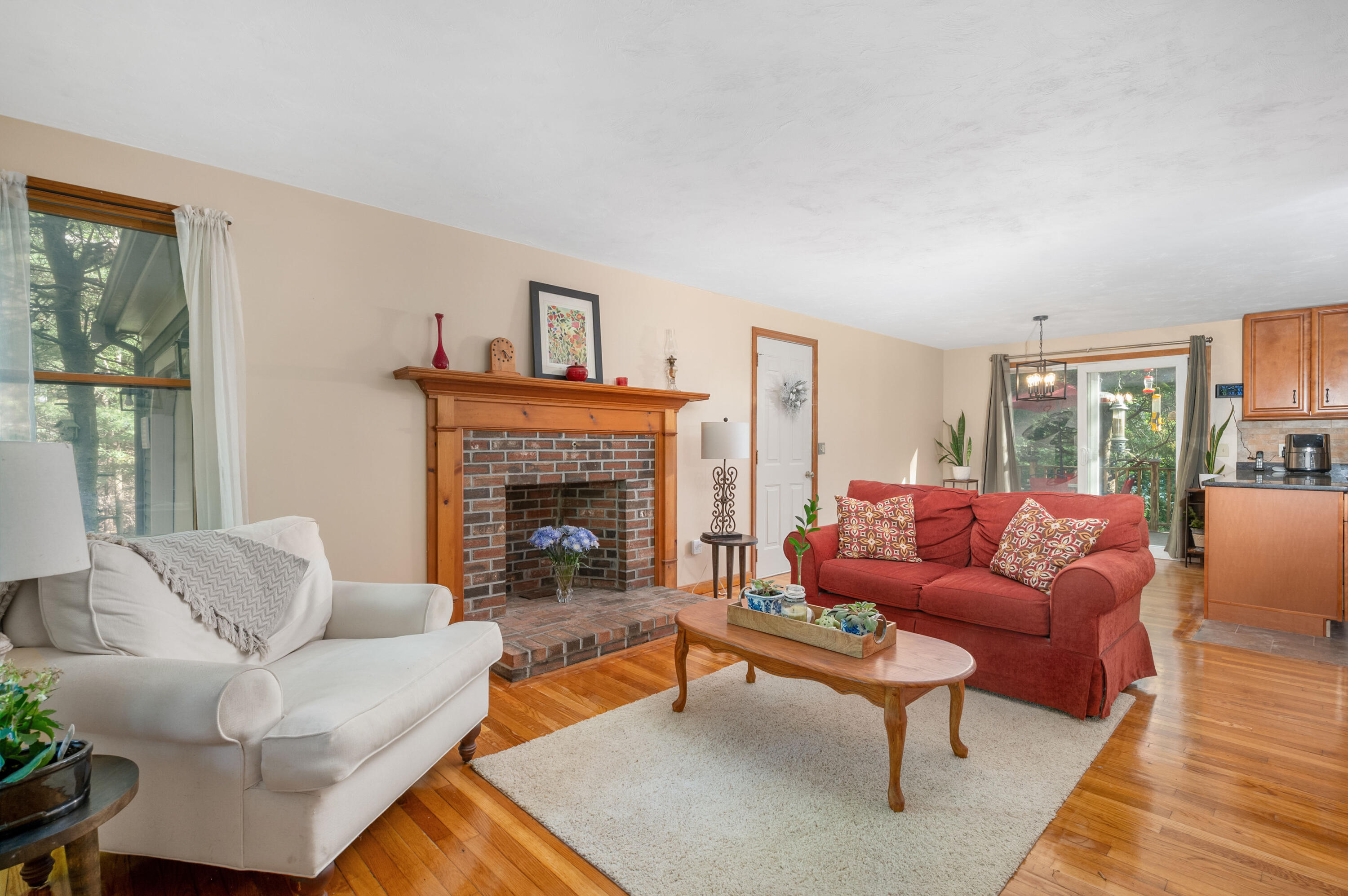 364 Jones Road Marstons Mills, MA 02648 - Photo 5 of 24 a living room with furniture a large window and a fireplace