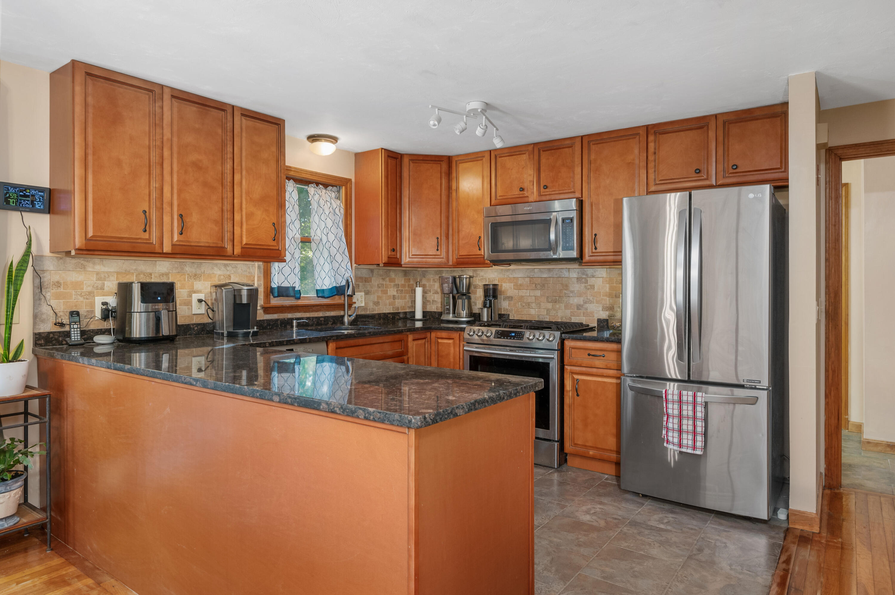 364 Jones Road Marstons Mills, MA 02648 - Photo 9 of 24 a kitchen with stainless steel appliances granite countertop a refrigerator stove a sink and a granite counter tops