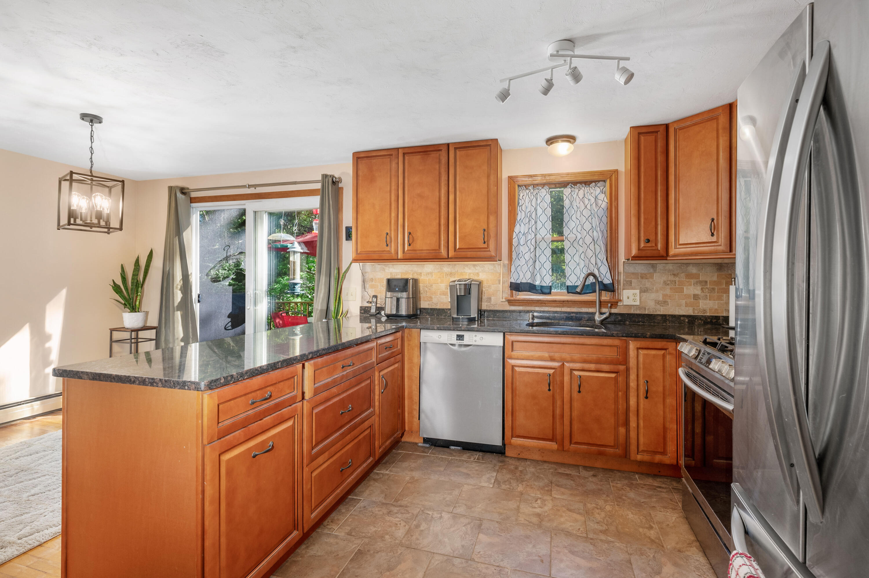 364 Jones Road Marstons Mills, MA 02648 - Photo 10 of 24 a kitchen with stainless steel appliances granite countertop a stove a sink and a refrigerator