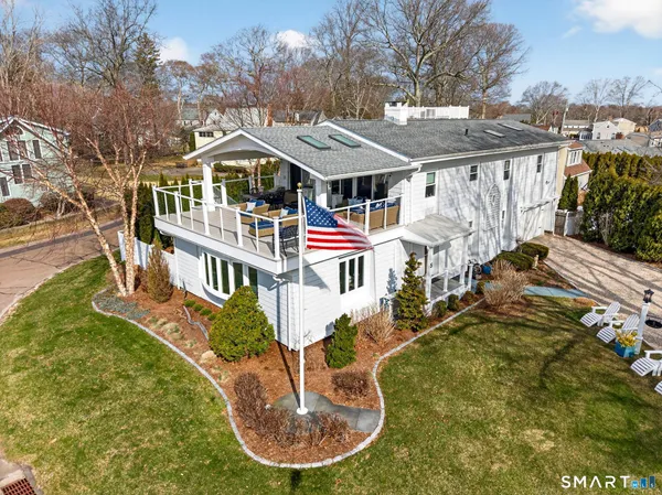 an aerial view of a house with a yard balcony