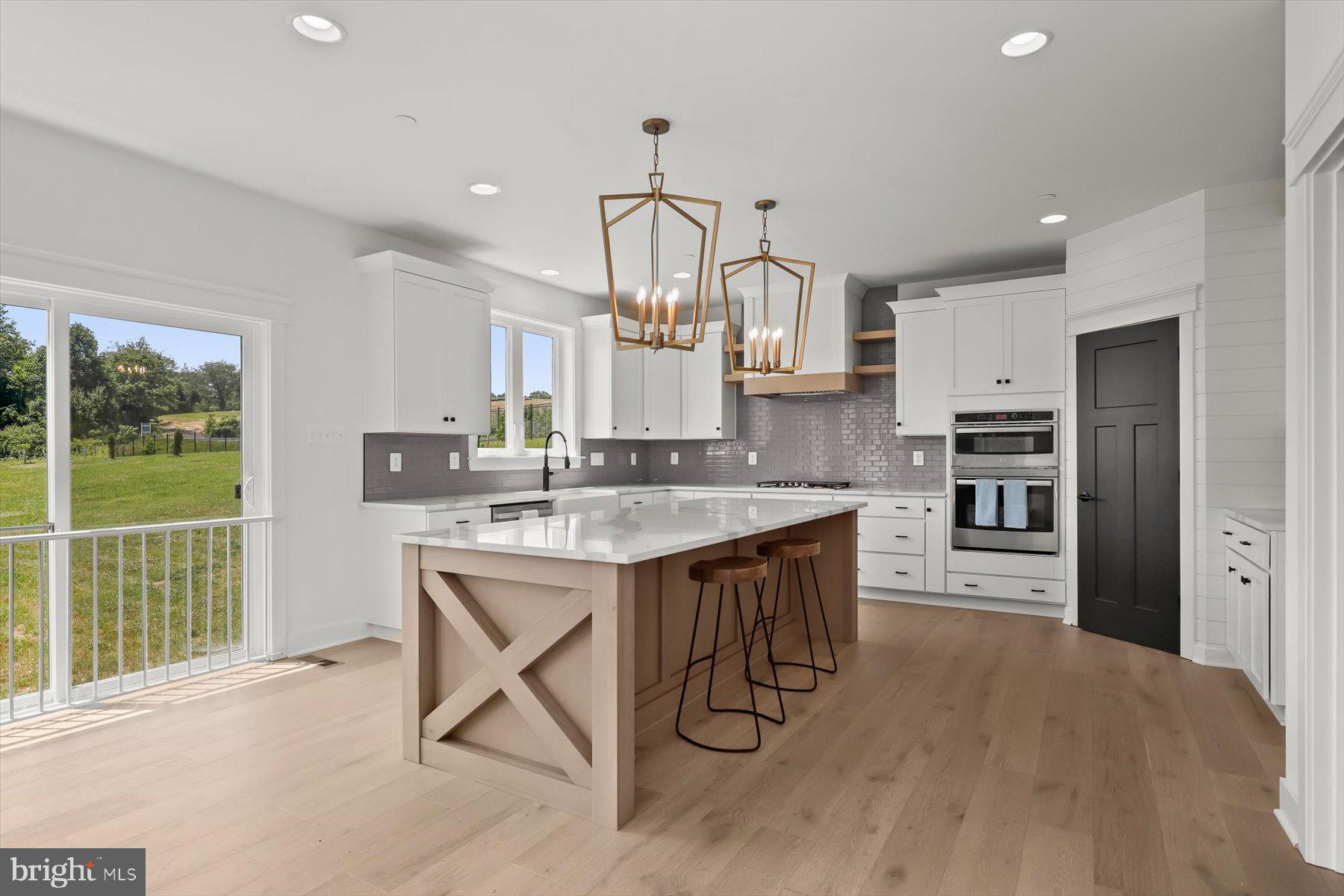 2 Snydersburg Road Westminster, MD 21157 - Photo 13 of 33 a kitchen with stainless steel appliances granite countertop a kitchen island hardwood floor and a sink