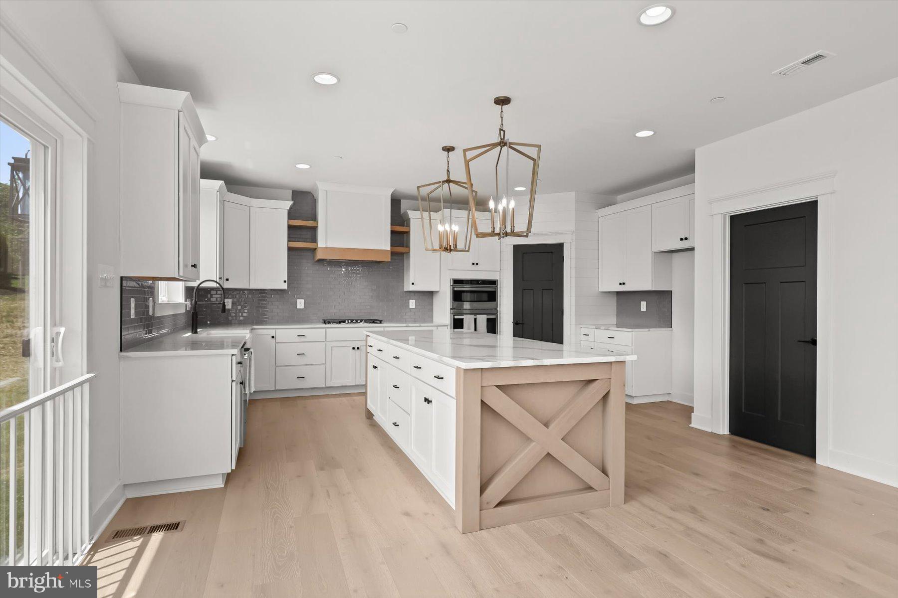 2 Snydersburg Road Westminster, MD 21157 - Photo 14 of 33 a kitchen with white cabinets and stainless steel appliances