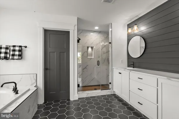 a spacious bathroom with a bathtub and a shower