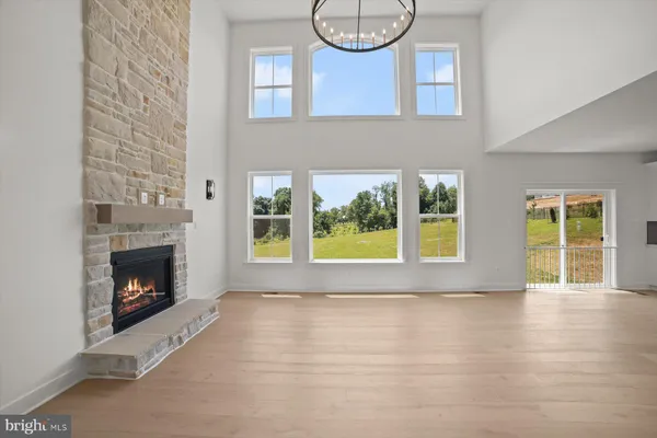 a view of an empty room with a fireplace and a window