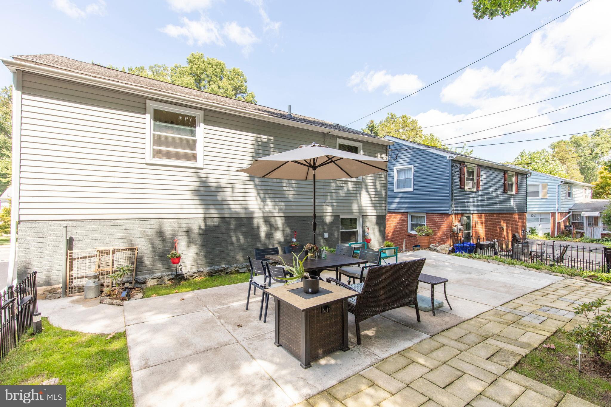 209 Glendale Road Havertown, PA 19083 - Photo 36 of 38 a view of a patio with a dining table and chairs under an umbrella