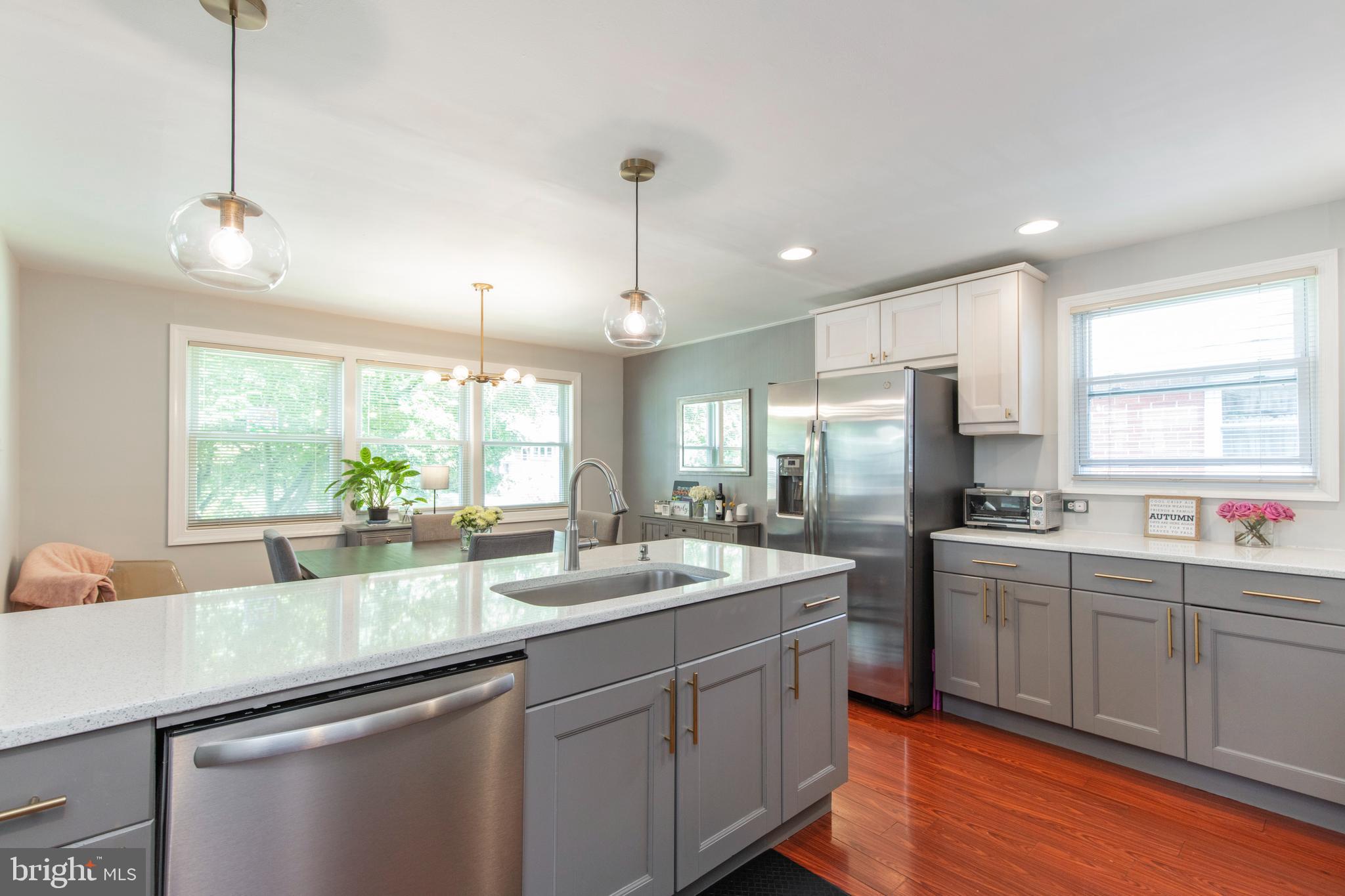 209 Glendale Road Havertown, PA 19083 - Photo 10 of 38 a large kitchen with kitchen island a sink appliances and a large window