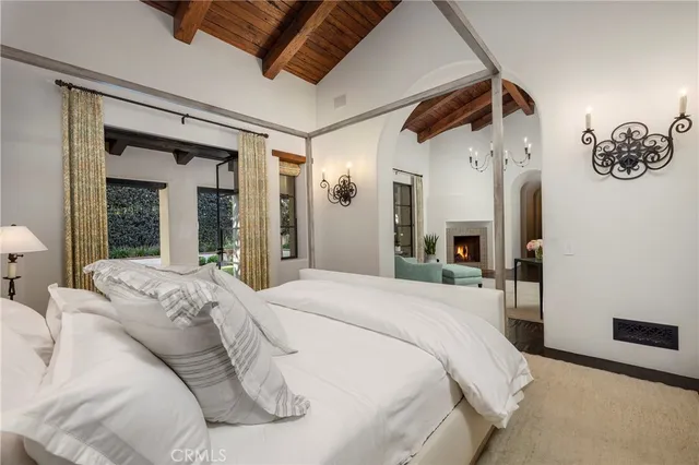 a large bedroom with a large bed and a large mirror