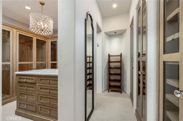 a bedroom with a balcony a bed and a chandelier