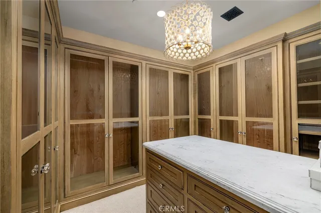 a bedroom with a large bed and windows