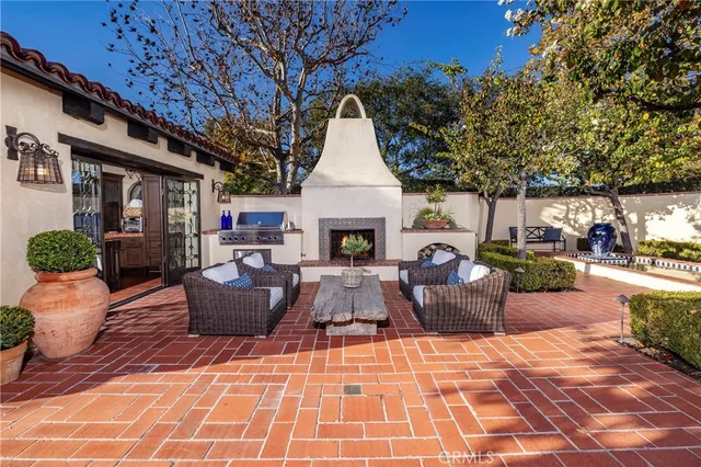 a view of a patio with couches table and chairs and potted plants