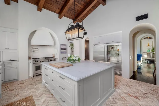a kitchen with stainless steel appliances granite countertop a stove and a refrigerator