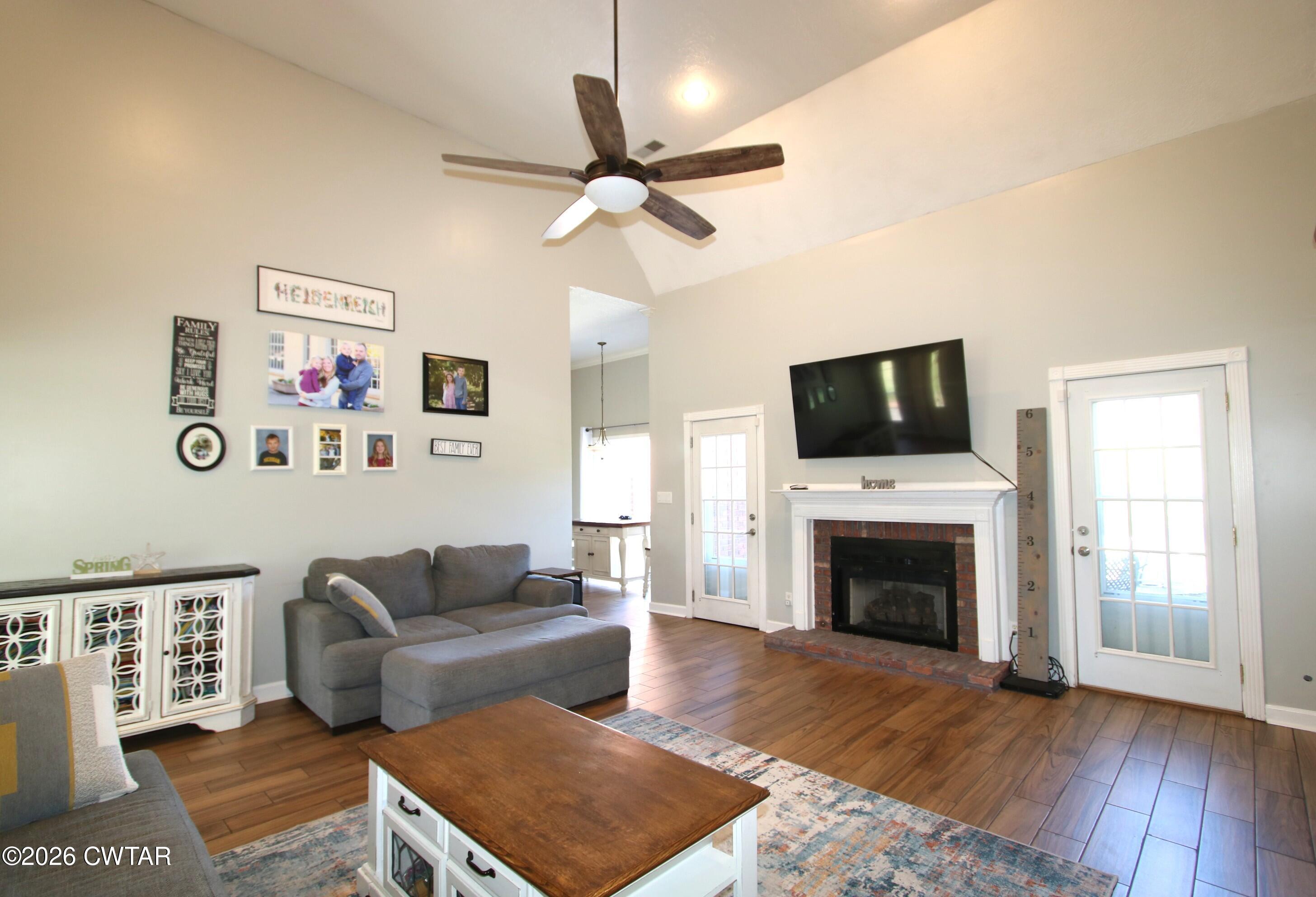 98 Browning Road Milan, TN 38358 - Photo 16 of 59 a living room with furniture a flat screen tv and a fireplace
