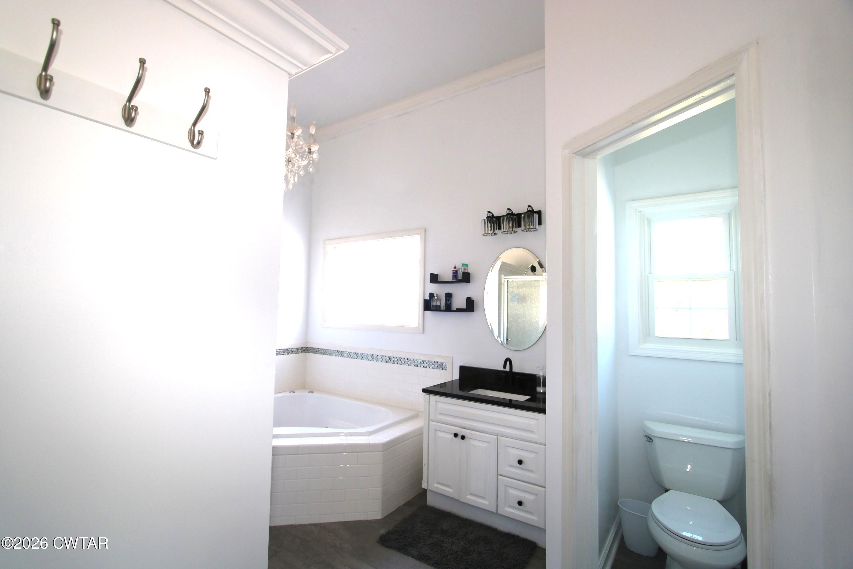 98 Browning Road Milan, TN 38358 - Photo 26 of 59 a bathroom with a sink a toilet and a mirror