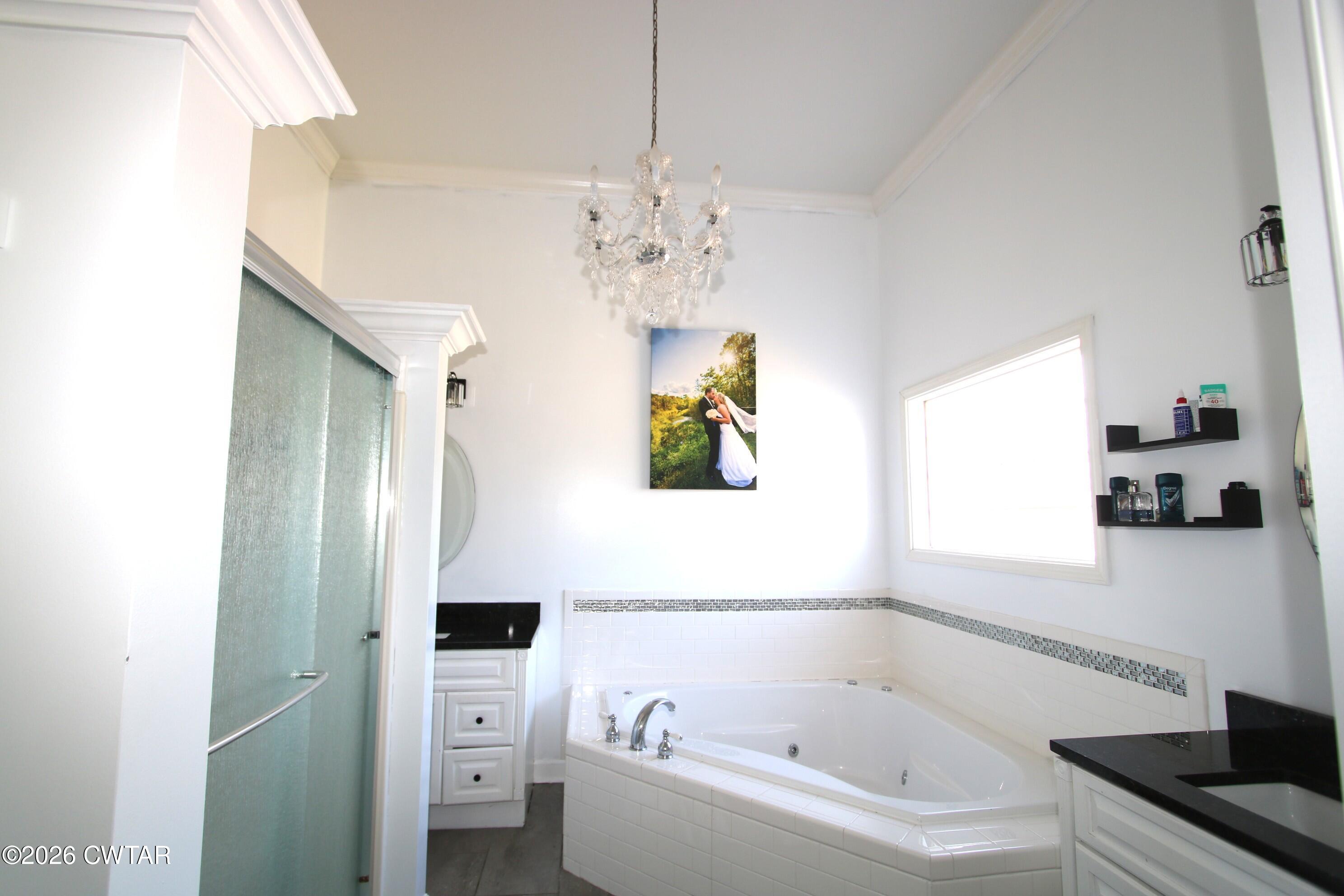98 Browning Road Milan, TN 38358 - Photo 27 of 59 a bathroom with a bathtub a sink and a window