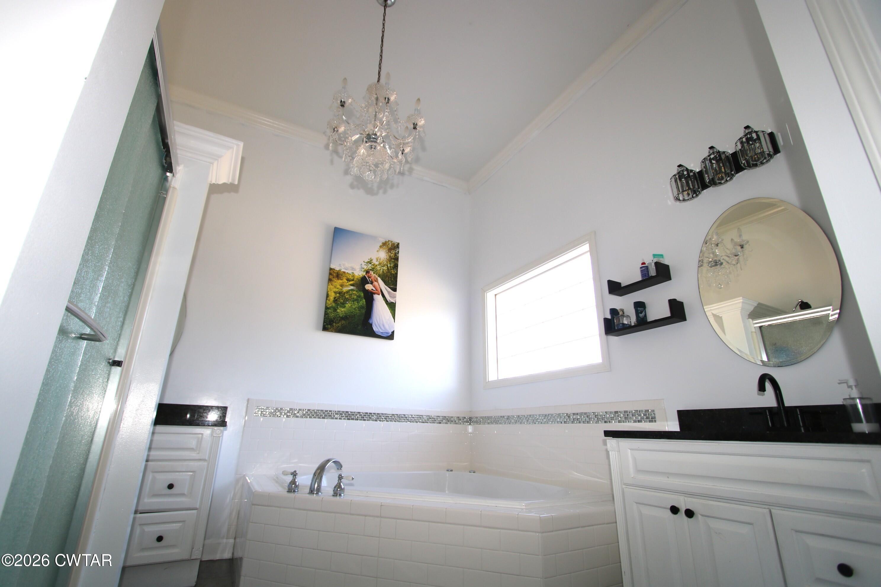 98 Browning Road Milan, TN 38358 - Photo 30 of 59 a bathroom with a sink a large mirror and vanity